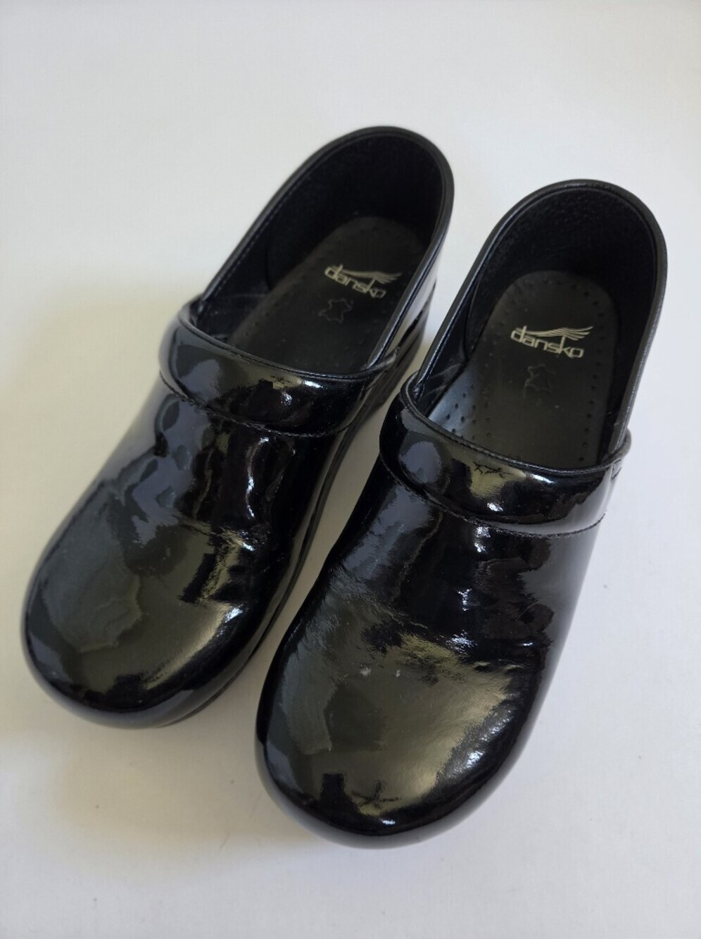 Like new! Dansko Professional clogs made with a black patent leather size 42